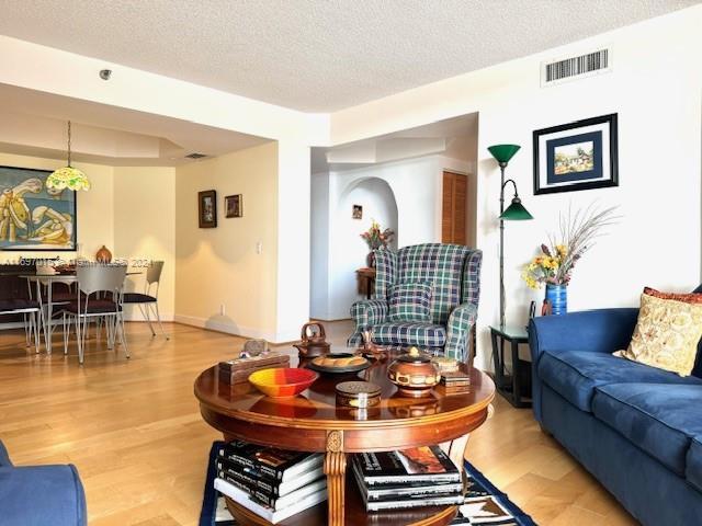 living room featuring a textured ceiling and hardwood / wood-style flooring