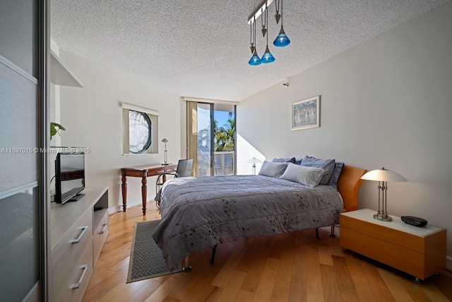 bedroom featuring a textured ceiling and light wood-type flooring