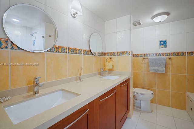 bathroom featuring a sink, tile walls, and tile patterned flooring