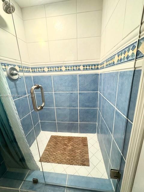 bathroom featuring tile patterned flooring and walk in shower