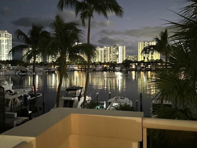 water view with a dock and a view of city lights