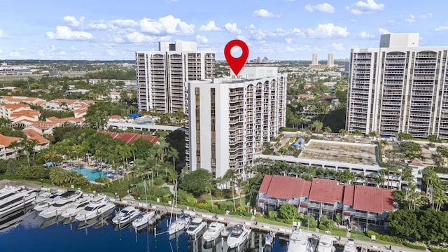 birds eye view of property with a water view and a city view