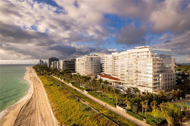 view of property with a water view and a view of the beach