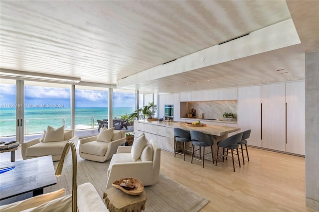 sunroom featuring a water view