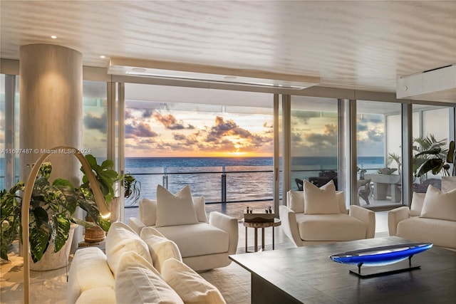 sunroom / solarium with a water view and a healthy amount of sunlight