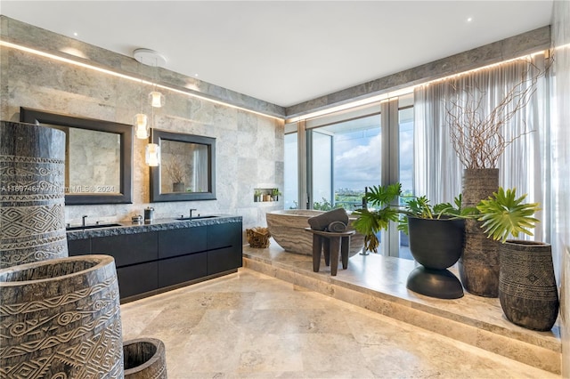 bathroom featuring vanity and tile walls