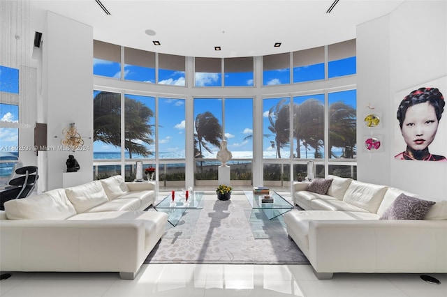 tiled living room with a towering ceiling