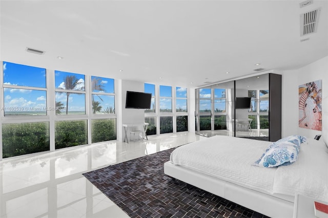 tiled bedroom with multiple windows and floor to ceiling windows