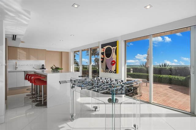 interior space with light tile patterned floors and sink