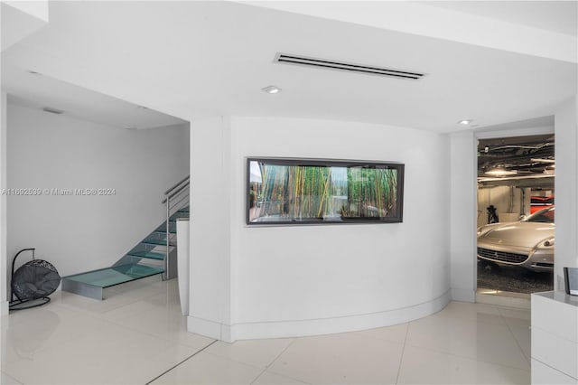 hall featuring light tile patterned floors