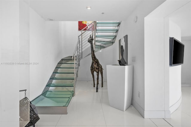 staircase featuring tile patterned flooring