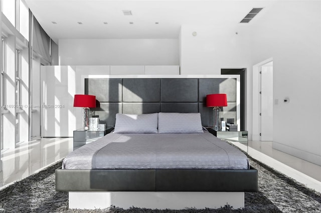 bedroom featuring a towering ceiling