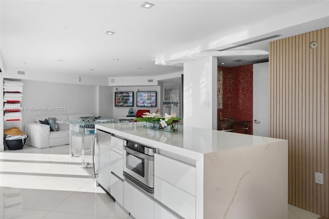 kitchen featuring white cabinets, stainless steel appliances, and a spacious island