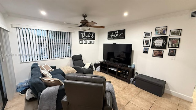 living room featuring crown molding, light tile patterned flooring, and ceiling fan