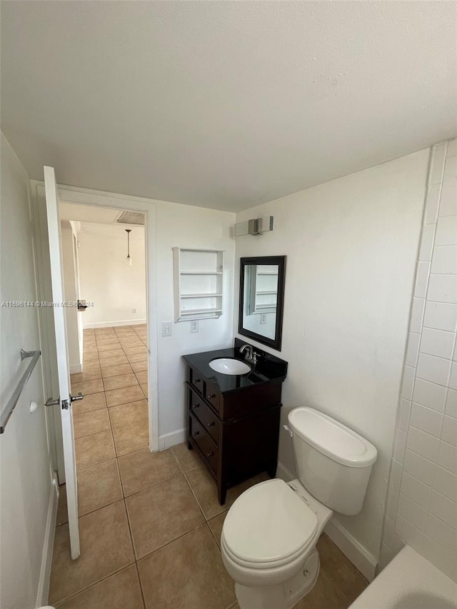 bathroom featuring tile patterned flooring, vanity, and toilet