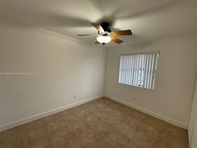 spare room with ceiling fan, light tile patterned flooring, and ornamental molding