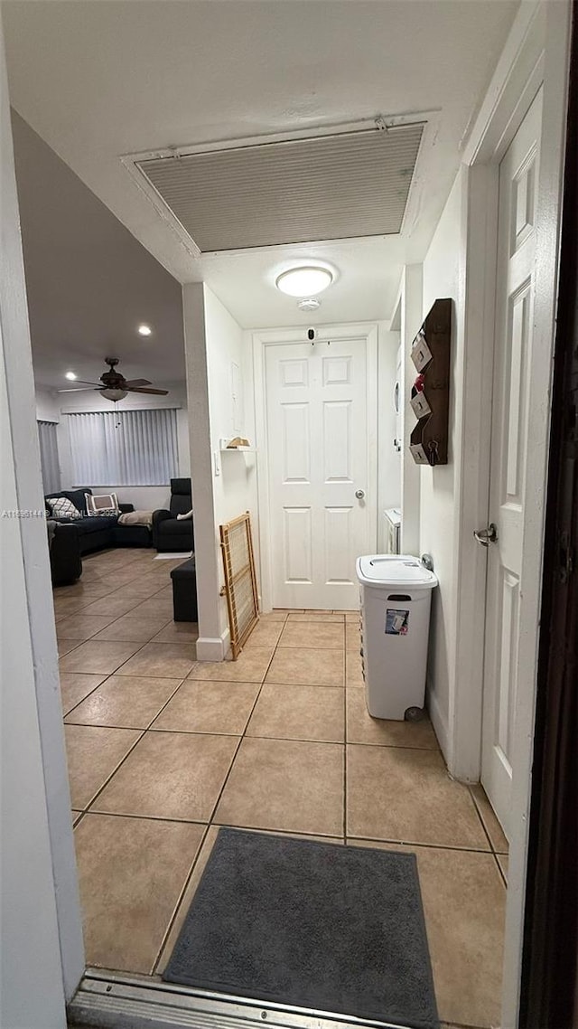 hall featuring light tile patterned flooring