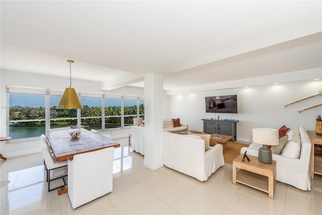 living area featuring baseboards and light tile patterned floors