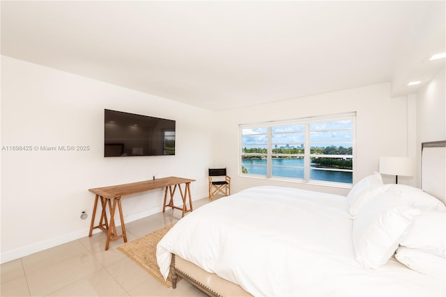bedroom with baseboards and light tile patterned floors