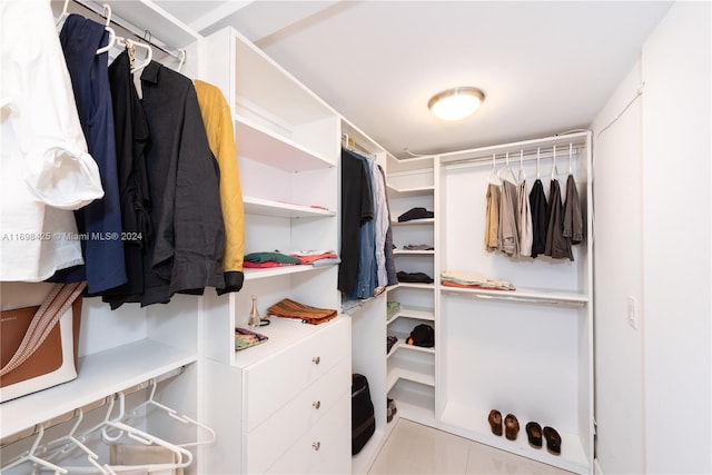 spacious closet with light tile patterned floors