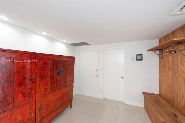 interior space with recessed lighting, baseboards, and light tile patterned flooring
