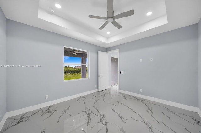 spare room with a tray ceiling