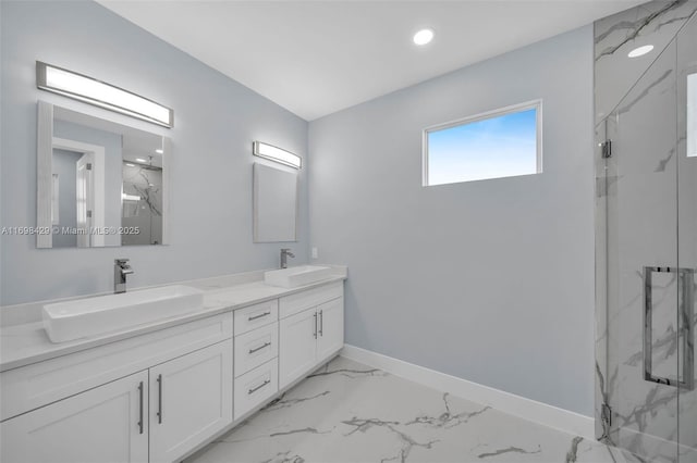 bathroom with a shower with shower door and vanity