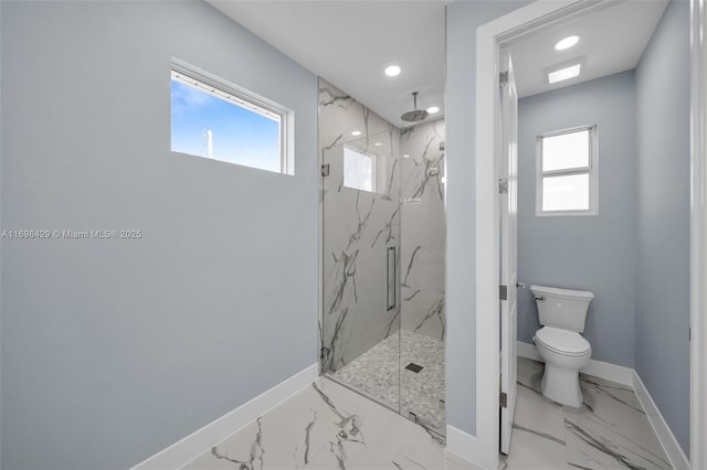 bathroom featuring toilet, a wealth of natural light, and a shower with shower door