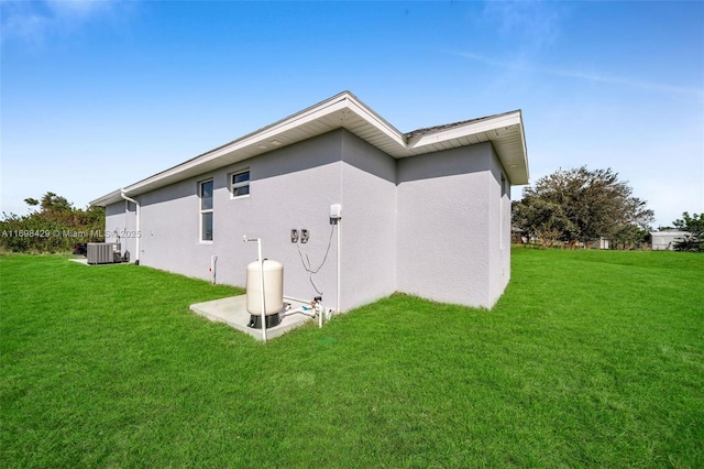 view of property exterior featuring a lawn and central AC