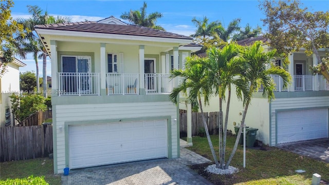 view of front of house featuring a garage and a balcony