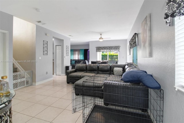 living room with ceiling fan and tile patterned floors