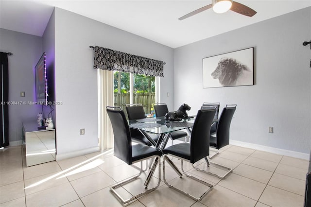 tiled dining room featuring ceiling fan