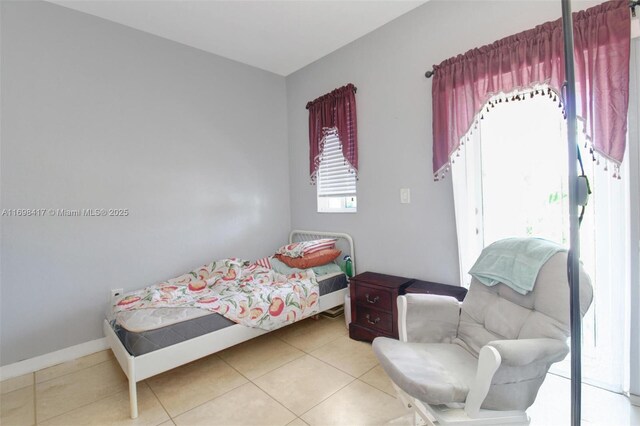 bedroom with light tile patterned floors