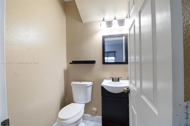 bathroom with toilet and vanity