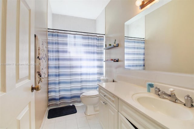 bathroom with toilet, tile patterned floors, vanity, and curtained shower