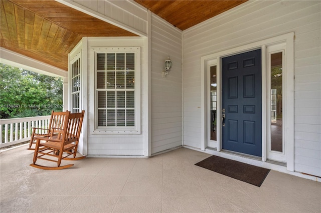 view of exterior entry with a porch