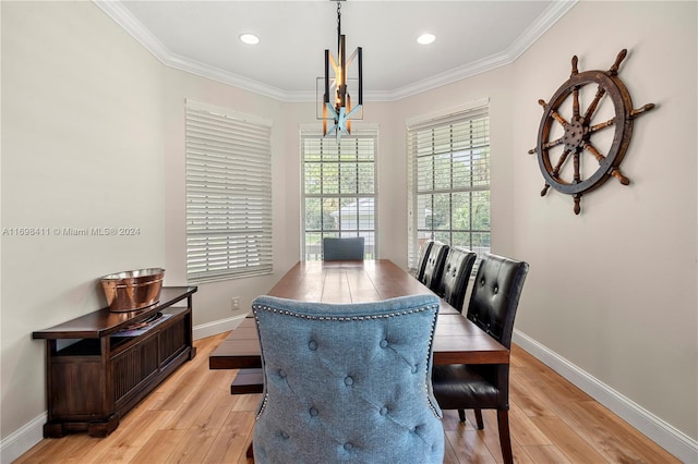 dining area featuring a chandelier, light hardwood / wood-style floors, and ornamental molding