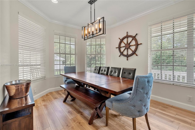 dining room featuring crown molding, light hardwood / wood-style flooring, and a notable chandelier