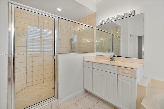 bathroom with tile patterned floors, vanity, and shower with separate bathtub