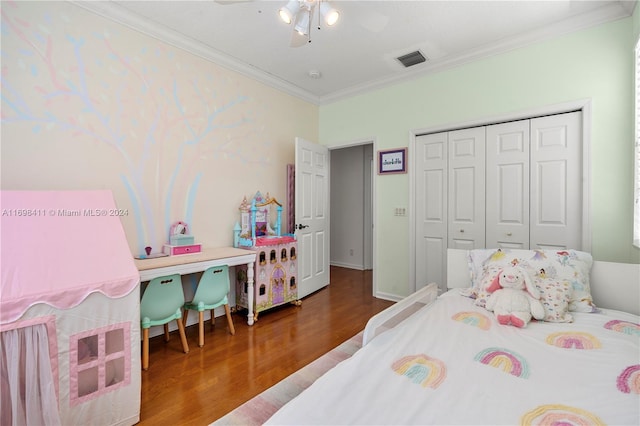 bedroom featuring hardwood / wood-style floors, ceiling fan, ornamental molding, and a closet