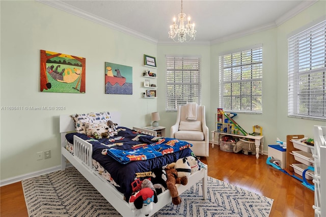 bedroom featuring a chandelier, hardwood / wood-style flooring, and crown molding