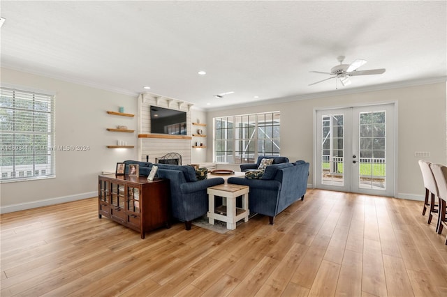 living room featuring french doors, light hardwood / wood-style flooring, a healthy amount of sunlight, and crown molding