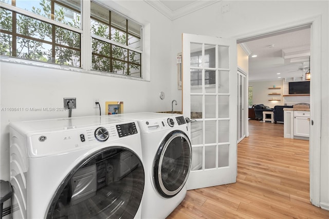 washroom featuring light hardwood / wood-style floors, ornamental molding, and washing machine and clothes dryer