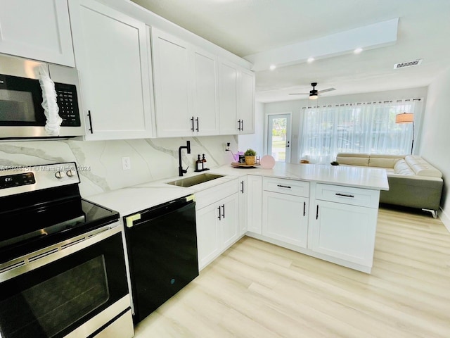 kitchen featuring kitchen peninsula, white cabinetry, sink, and appliances with stainless steel finishes