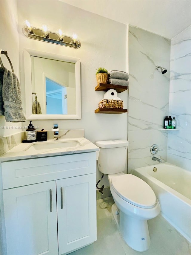 full bathroom featuring toilet, vanity, and tiled shower / bath