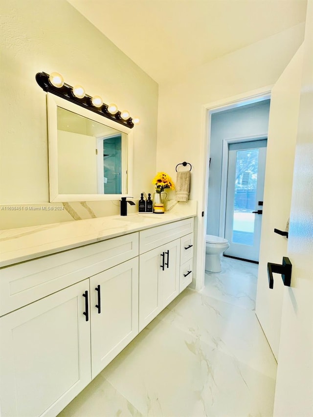 bathroom with vanity and toilet