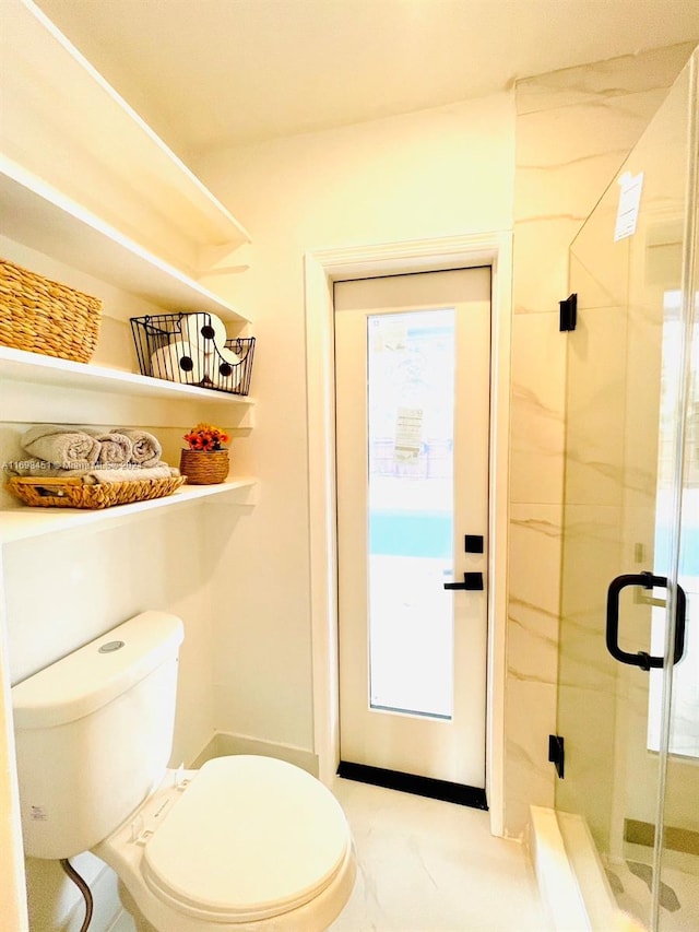 bathroom with toilet, plenty of natural light, and walk in shower