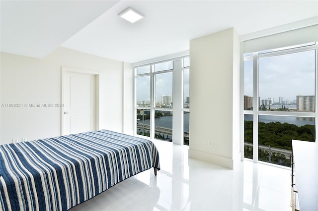 bedroom featuring light tile patterned flooring and a wall of windows