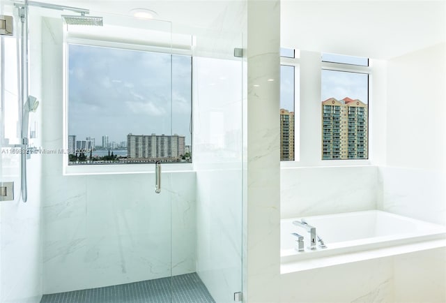 bathroom featuring shower with separate bathtub