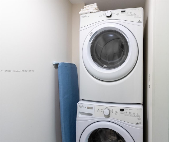 laundry room with stacked washer / drying machine